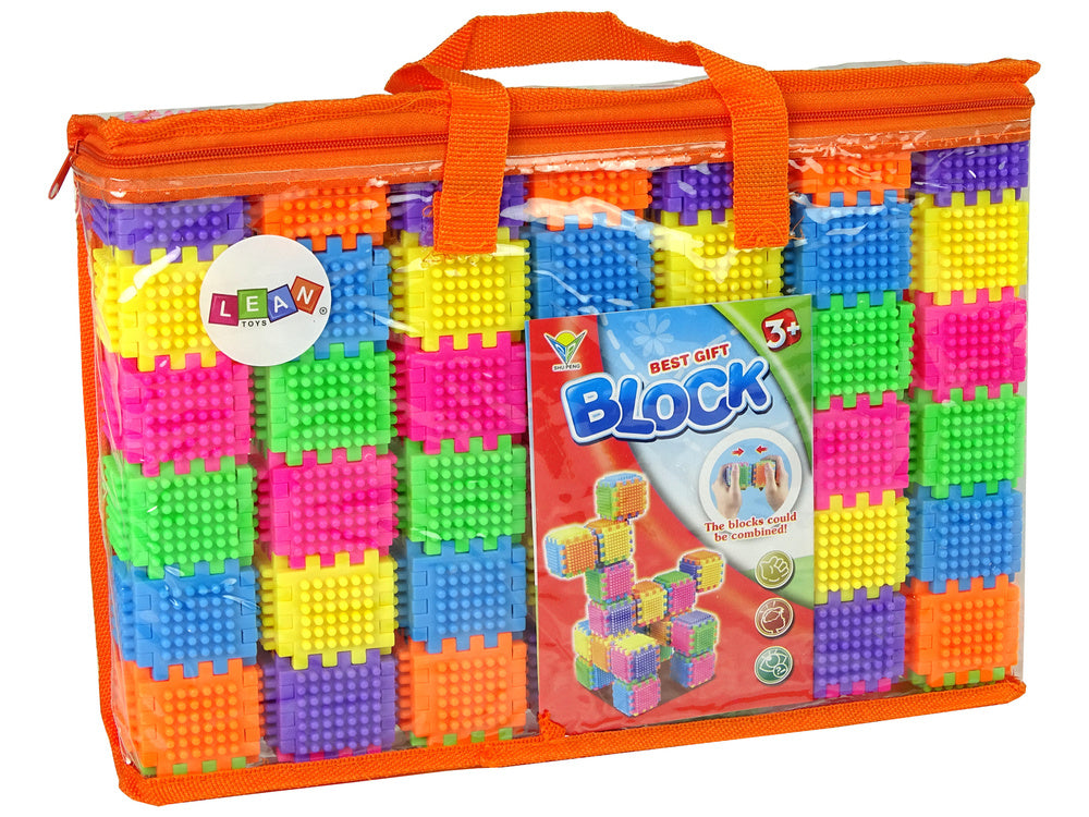 Krāsains klucīšu komplekts oranžā pārnēsāšanas somā ar LEAN toys zīmola etiķeti.