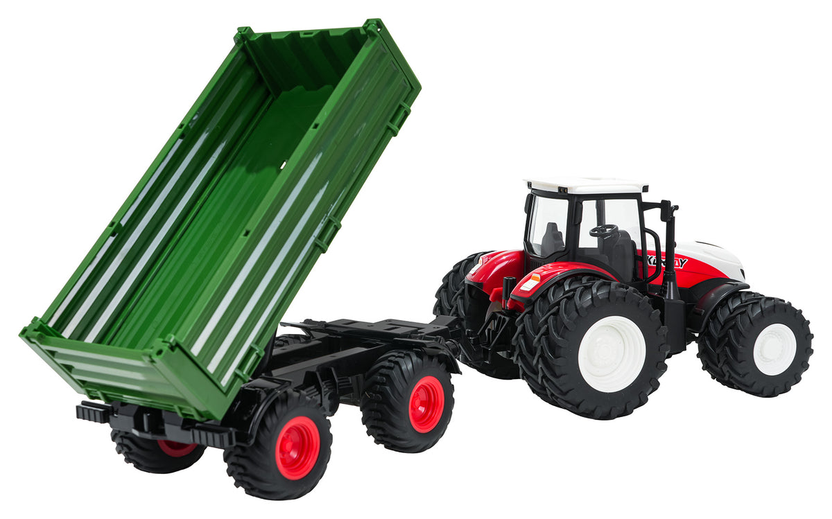 KORUDY tālvadības traktors mērogā 1:24 ar zaļu divasu pašizgāzēja piekabi, paceltu kravas kasti un lielām gumijas riepām, skats no aizmugures un sāniem ar demonstrētu piekabes izkraušanas funkciju