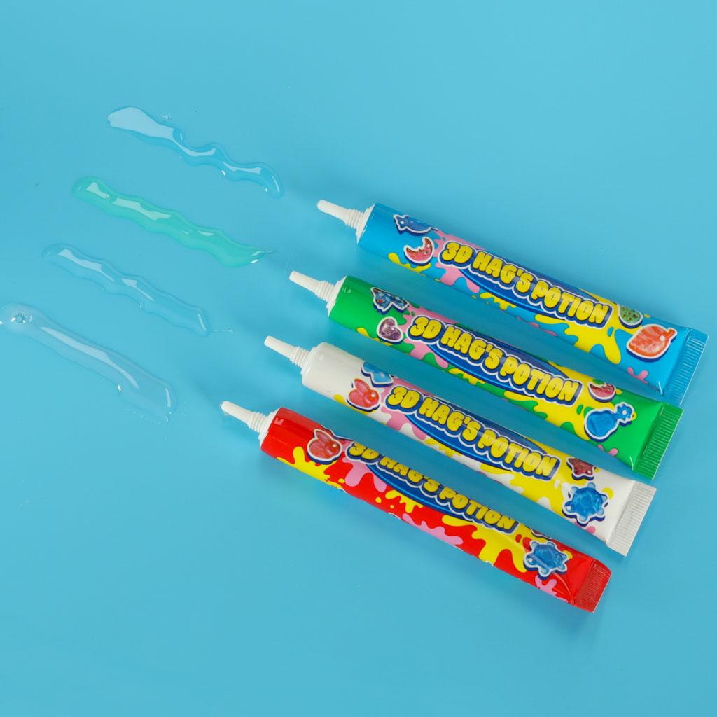 Magic Box komplekta krāsainās gēla līmes – paraugi uzklāti uz zilas virsmas