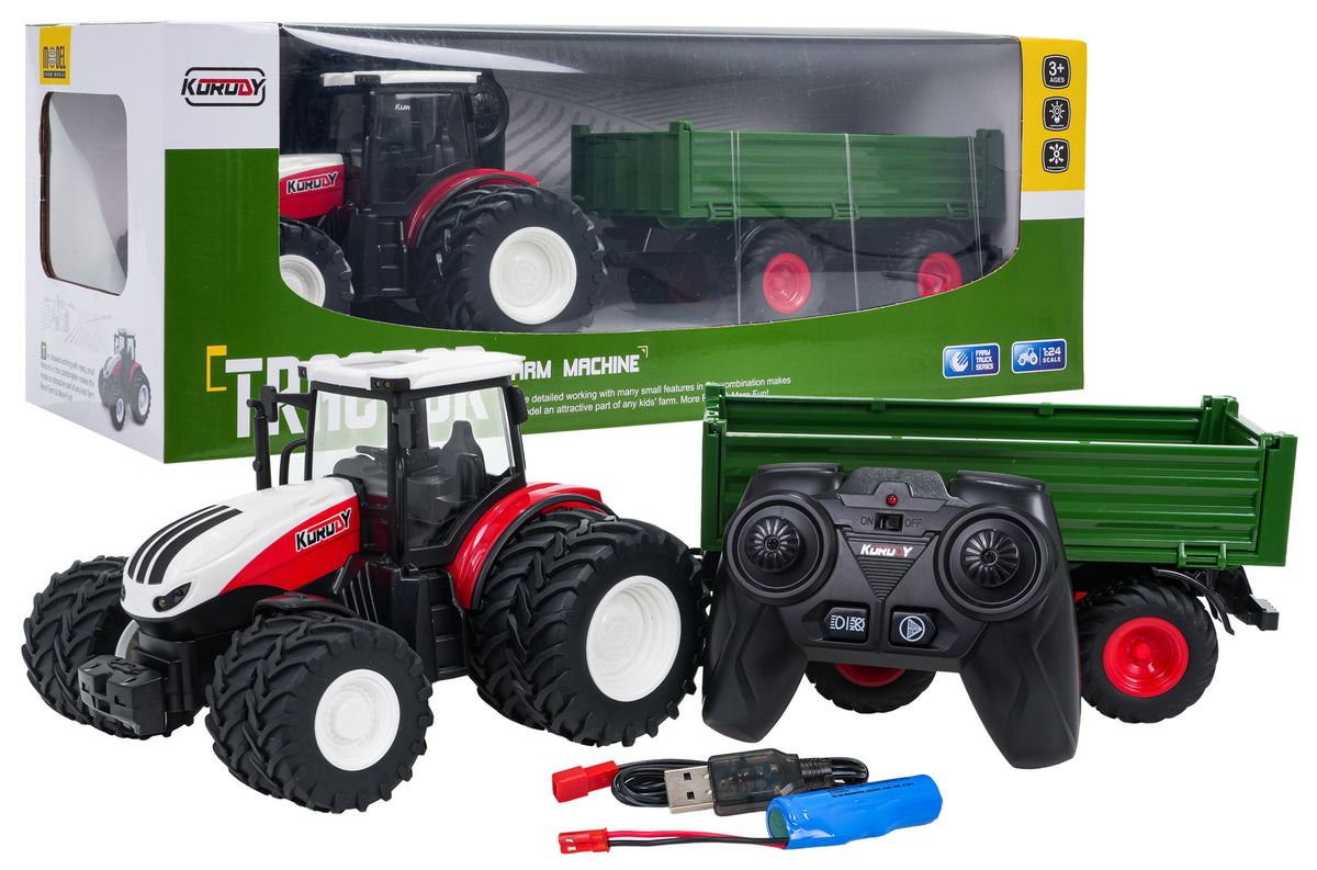 Sarkans un balts tālvadības traktors ar dubultajiem riteņiem, zaļu piekabi, pulti, akumulatoru un USB uzlādes kabeli blakus iepakojumam

