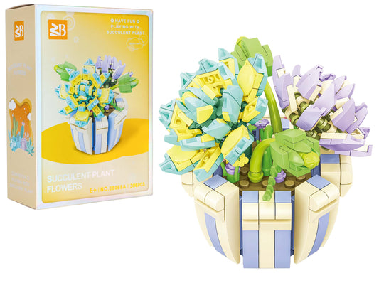 Ziedu klucīšu kompozīcija podā no 306 detaļām ar pasteļtoņu ziediem un zaļiem augiem, komplekts ar iepakojumu